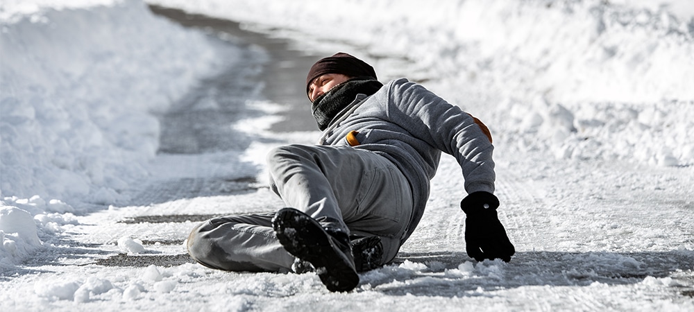 man fall on slippery snow